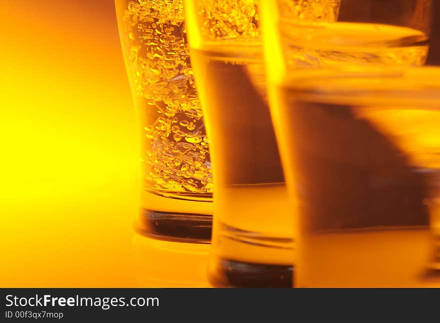 Liquid filled glasses with yellow back lighting.