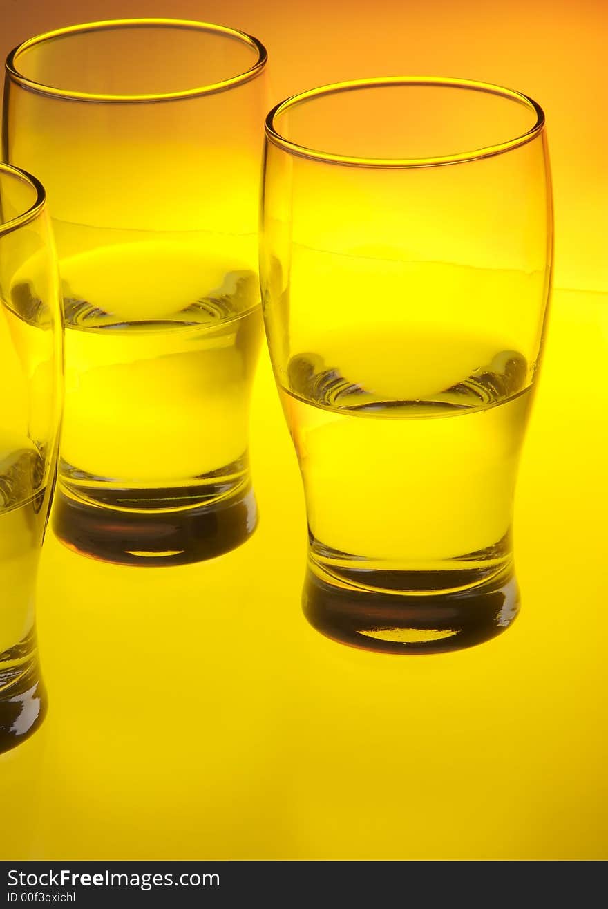 Liquid filled glasses with yellow backlighting.