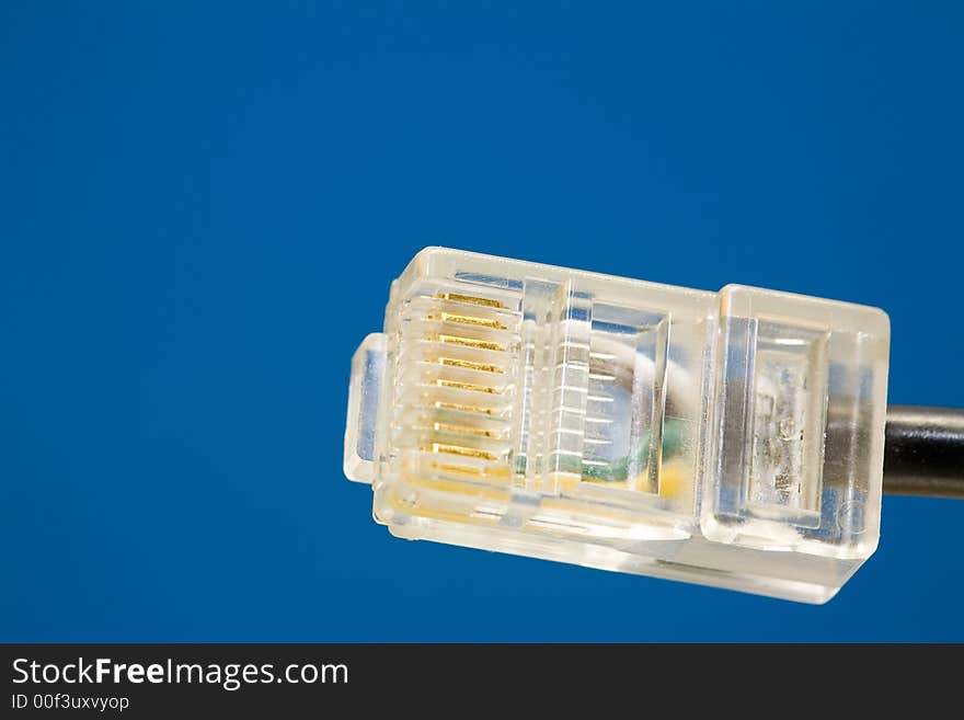 Single RJ45-Plug. Close-Up, blue background. Copyspace. Single RJ45-Plug. Close-Up, blue background. Copyspace.