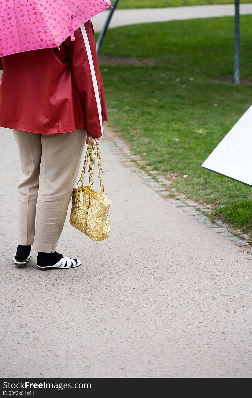 A woman from behind, standing in a park. Very tasteless clothes. A woman from behind, standing in a park. Very tasteless clothes...