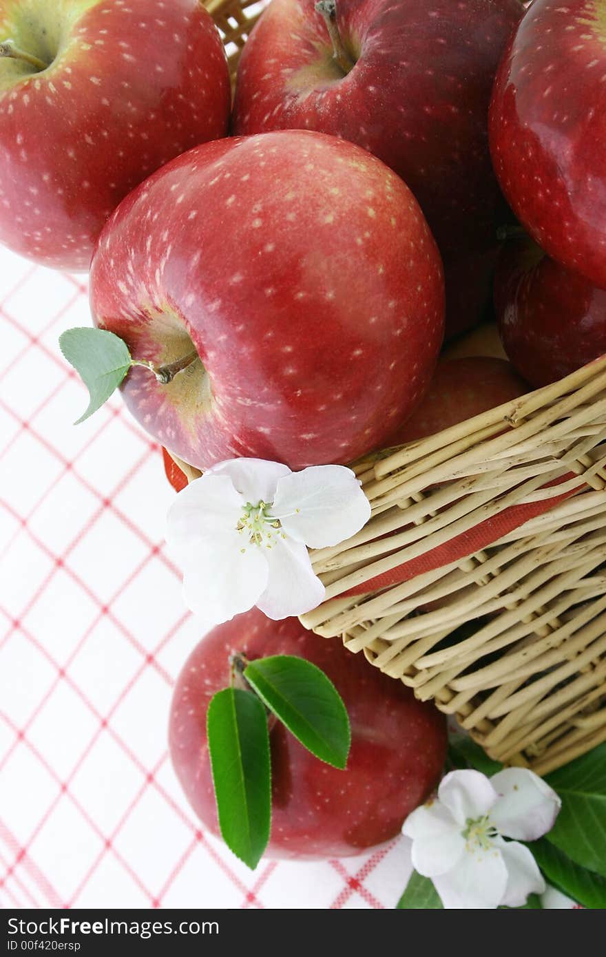 Red apples and white flower in a basket. Red apples and white flower in a basket