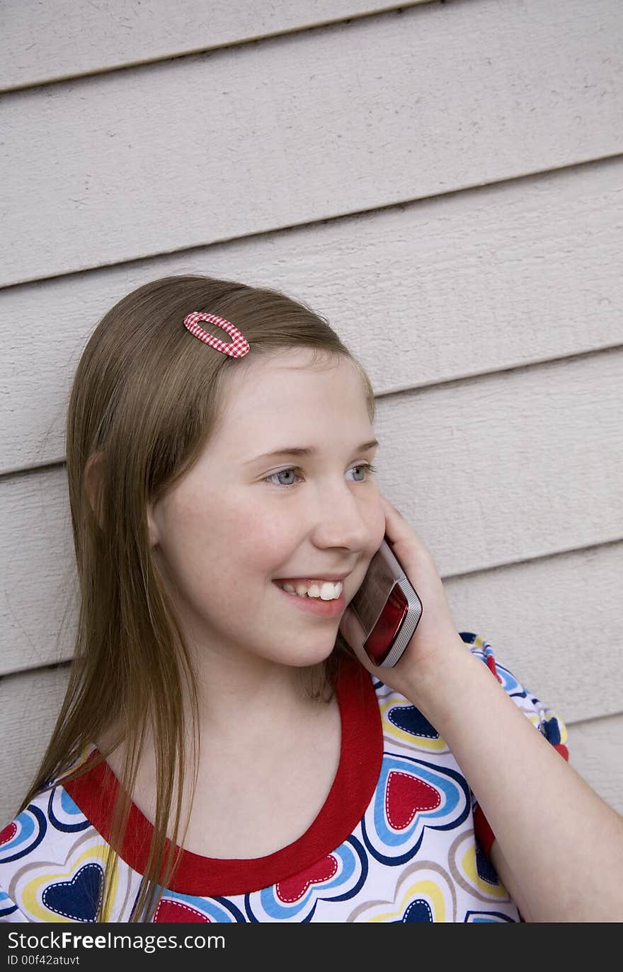 Image of a preteen girl on her cell phone. Image of a preteen girl on her cell phone