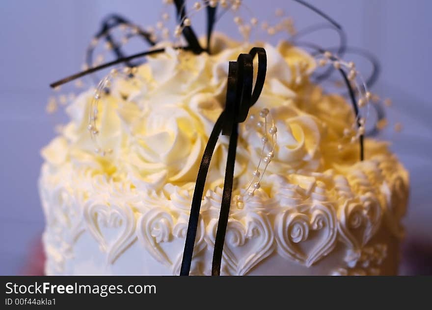 Top of a wedding cake with black lace and ivory pearls. Top of a wedding cake with black lace and ivory pearls