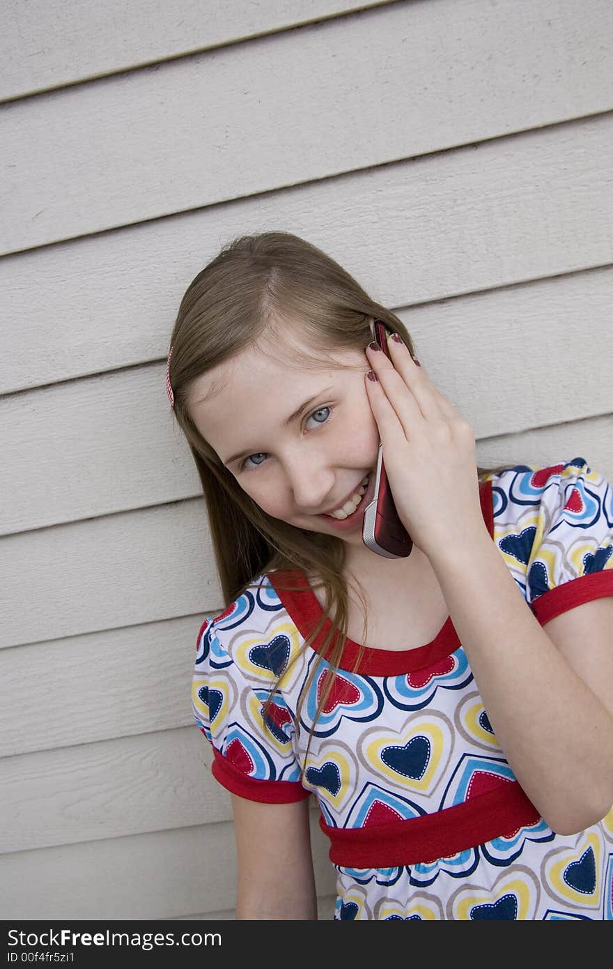 Preteen cutie talking on her cell phone. Preteen cutie talking on her cell phone