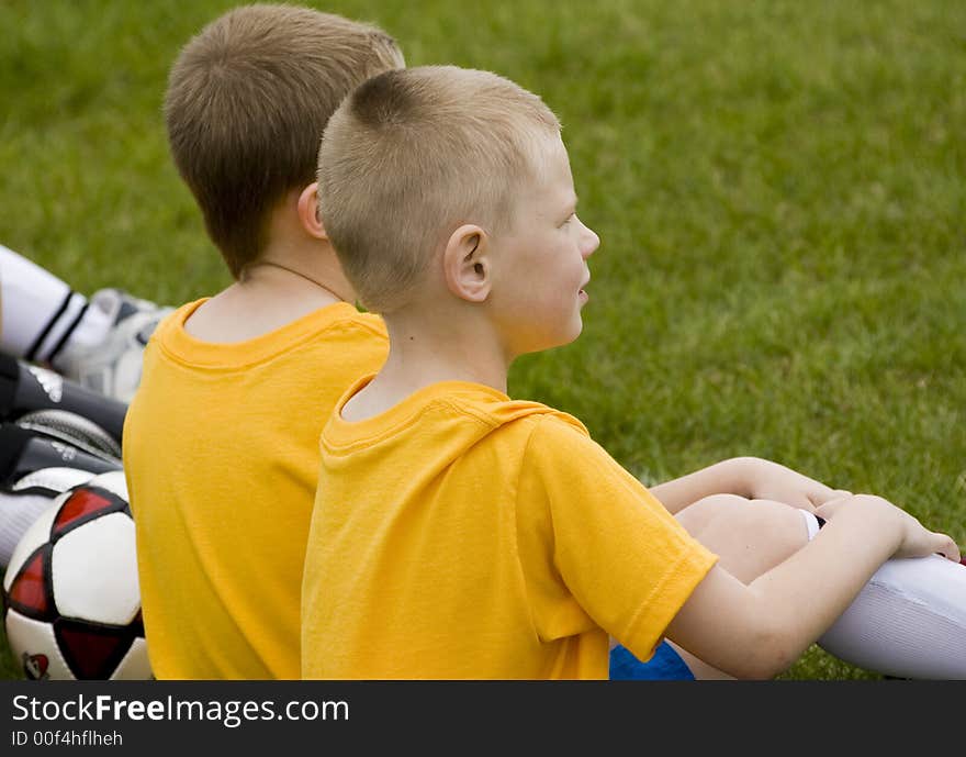 Here is a photo of two young boys waiting patiently on the sideline for their turn to play soccer. Here is a photo of two young boys waiting patiently on the sideline for their turn to play soccer.