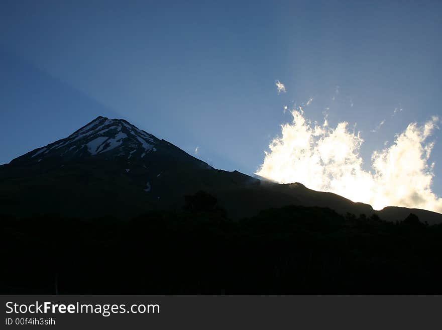 Mount Egmont at sunset with a ray of light. Mount Egmont at sunset with a ray of light