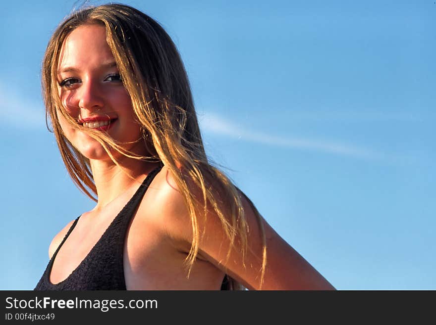 Portrait of  young woman in  early morning on  background of  blue sky. Portrait of  young woman in  early morning on  background of  blue sky