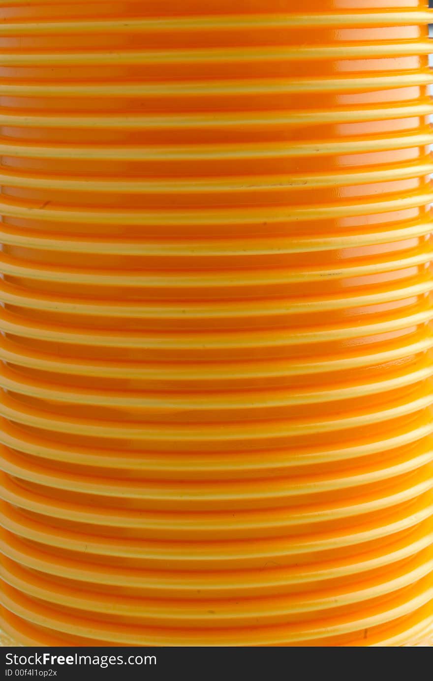 Packing of disposable plastic glasses rhythmically stacked yellow color