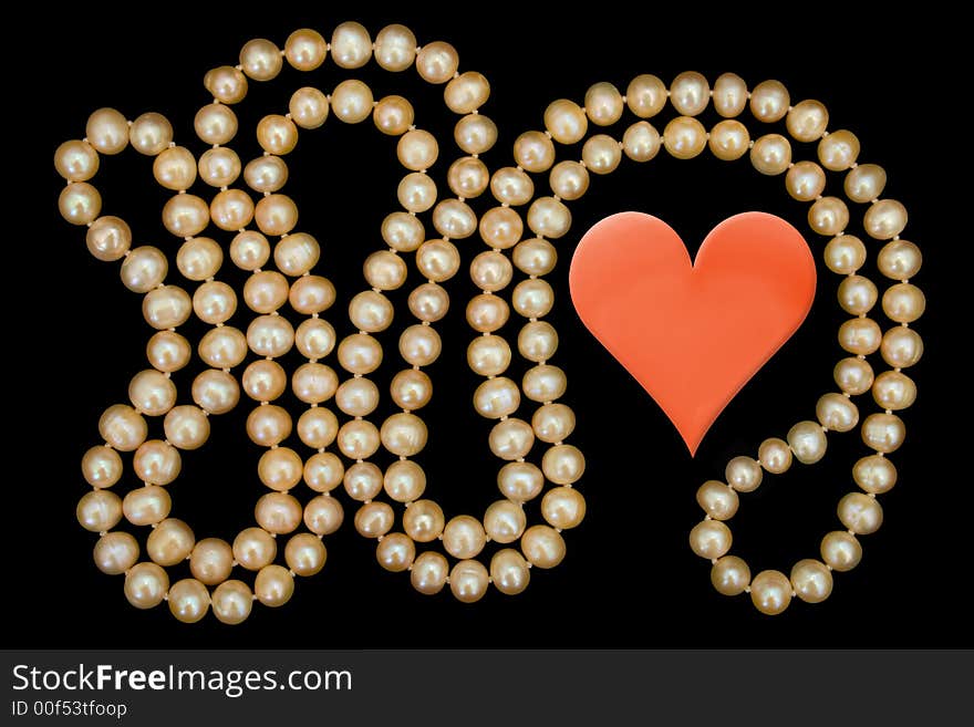 Heart and pearly necklace, isolated on black background