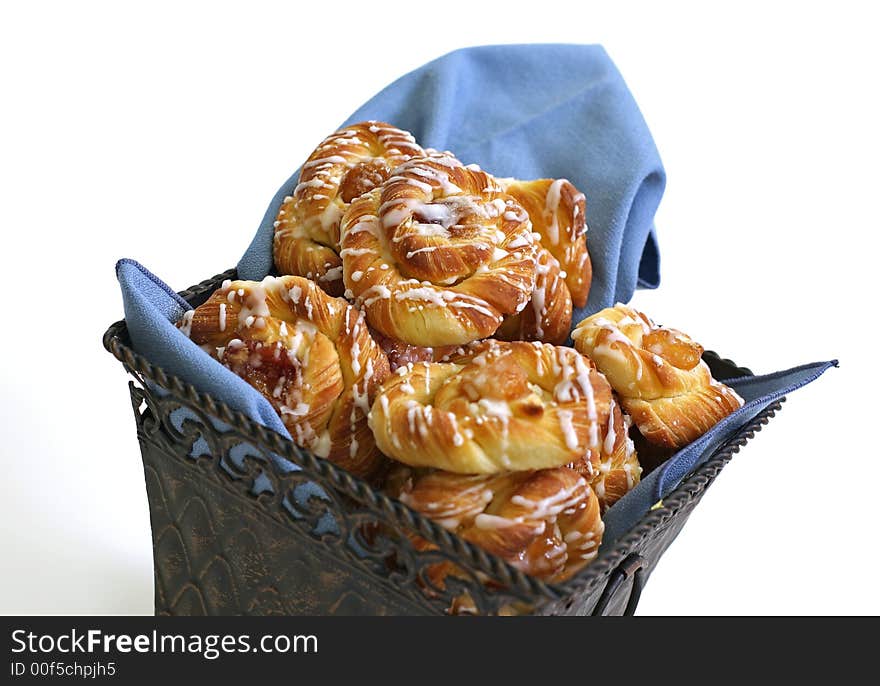 Sweet raspberry pastry with icing in the basket. Sweet raspberry pastry with icing in the basket