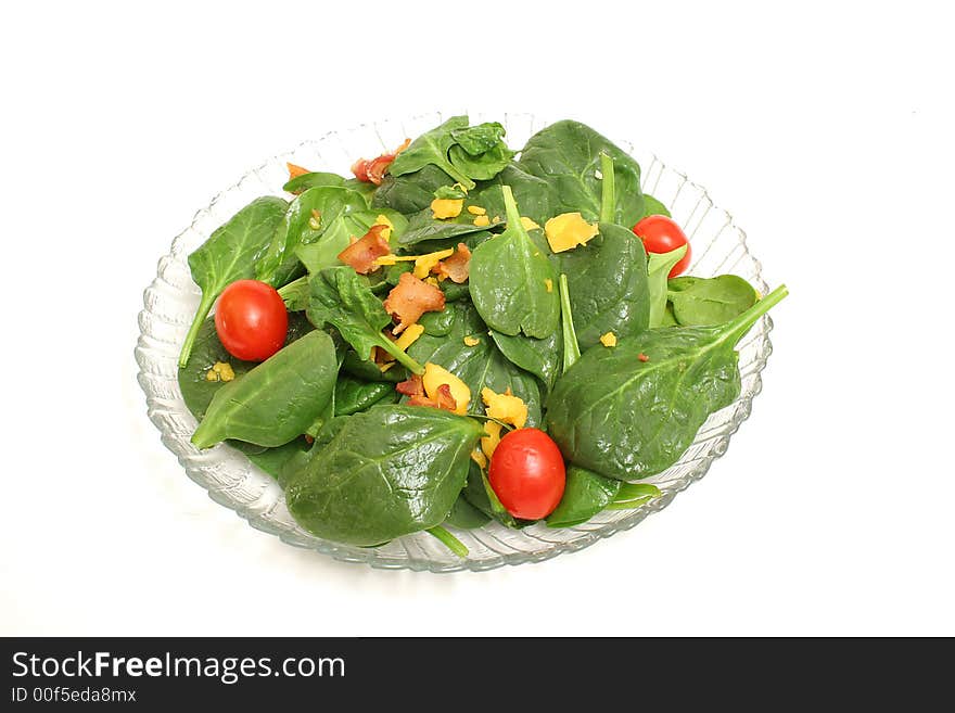 Isolated photo of a spinach salad on white background