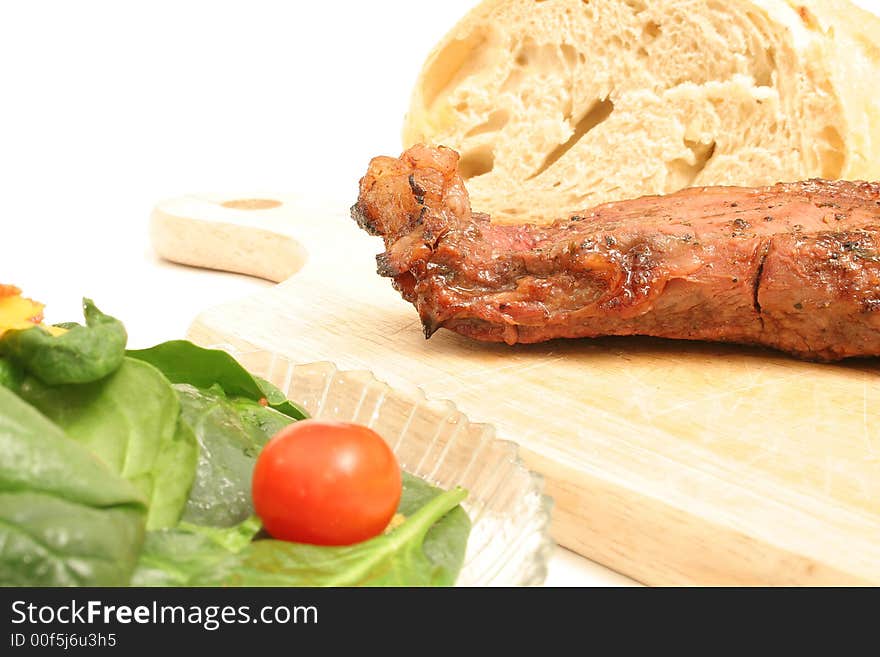 Salad and steak on white