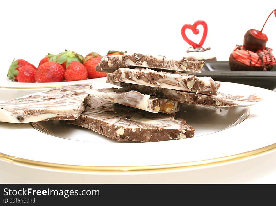 Isolated photo of chocolate candy and strawberrys level on white