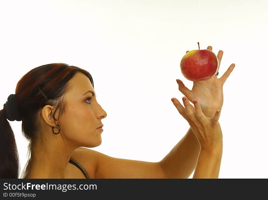 Healthy girl eating apples over a white background