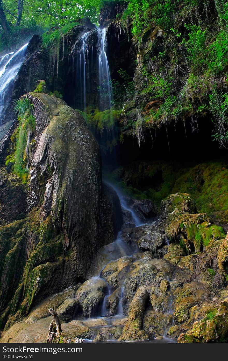 Waterfall with steam of water falling on rocks