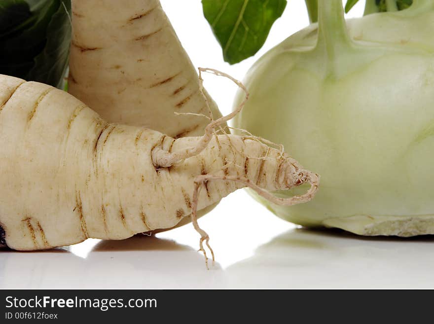 Root of parsley and kohlrabi over white background. Root of parsley and kohlrabi over white background