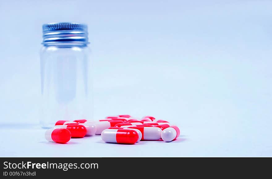 Pills next to an empty jar