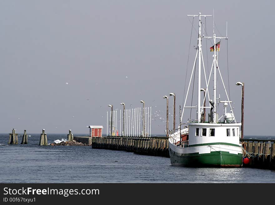 Fisherboat by a pier in harbour