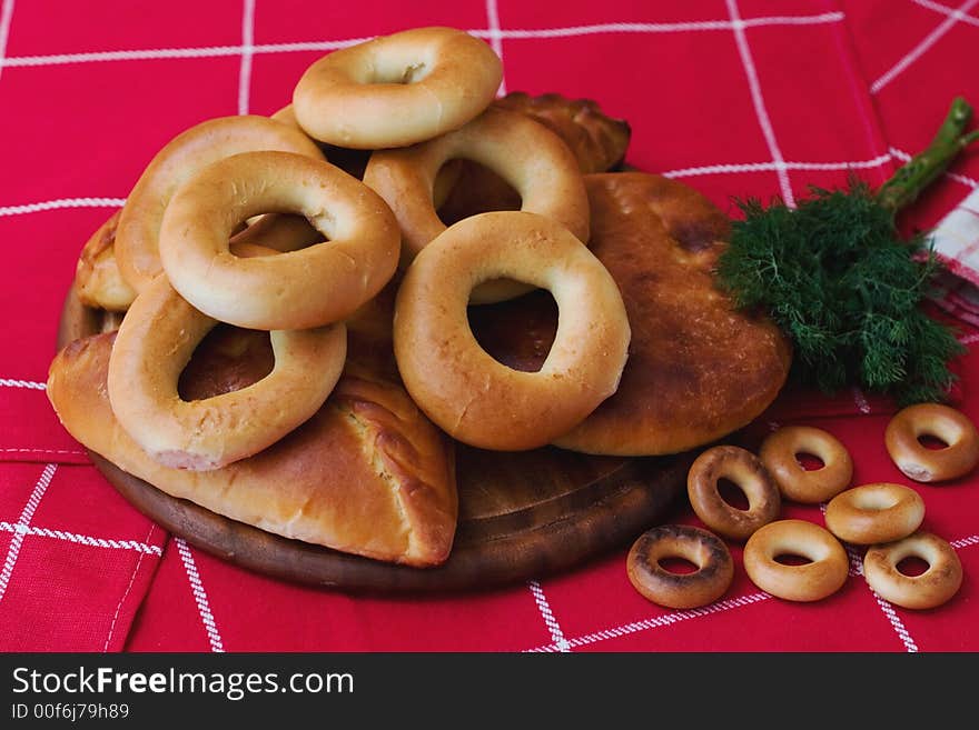 Pie and cracknels on the wooden plate. Pie and cracknels on the wooden plate