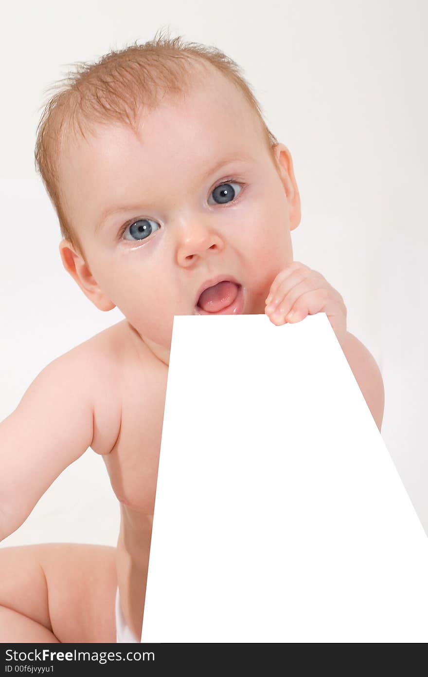 Cute little baby looking into camera, holding a paper sheet. Cute little baby looking into camera, holding a paper sheet