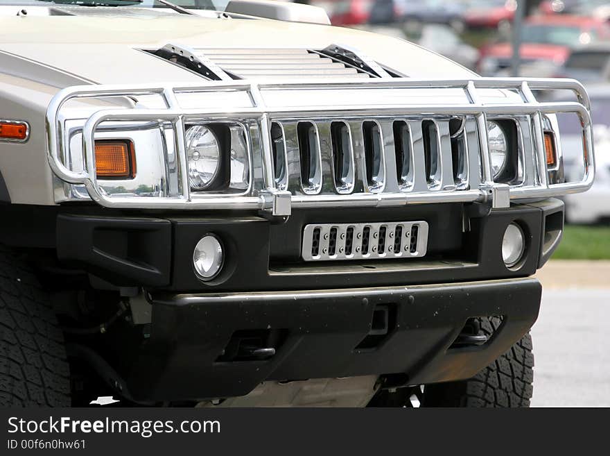 Front end and grill of a gray SUV. Front end and grill of a gray SUV