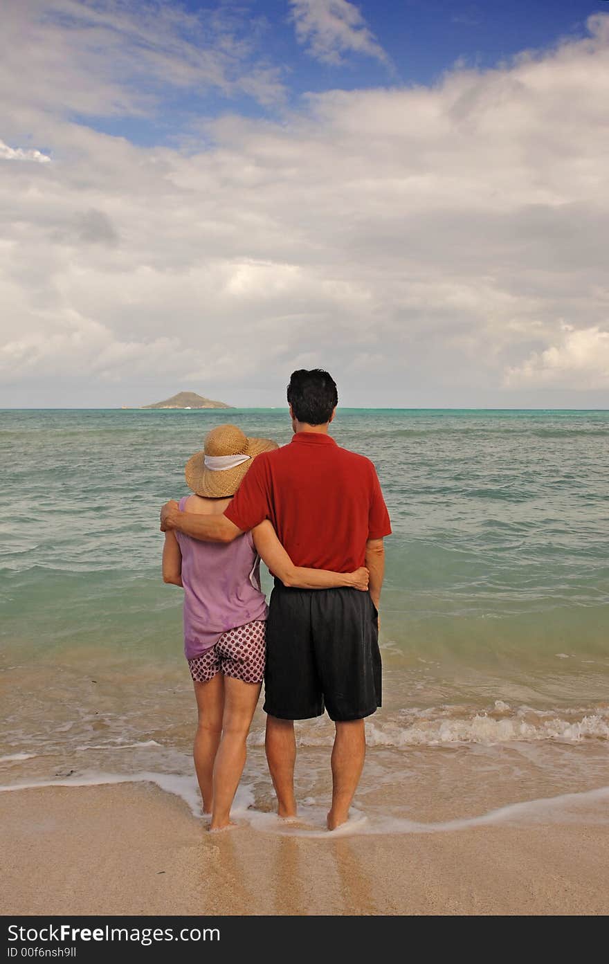 Mid-life aged romantic couple together on a tropical beach. Mid-life aged romantic couple together on a tropical beach