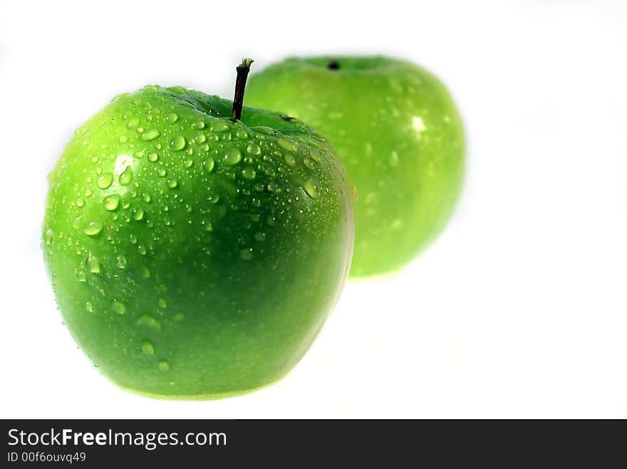 Two Clouse-up macro green apple on the white background. Two Clouse-up macro green apple on the white background.