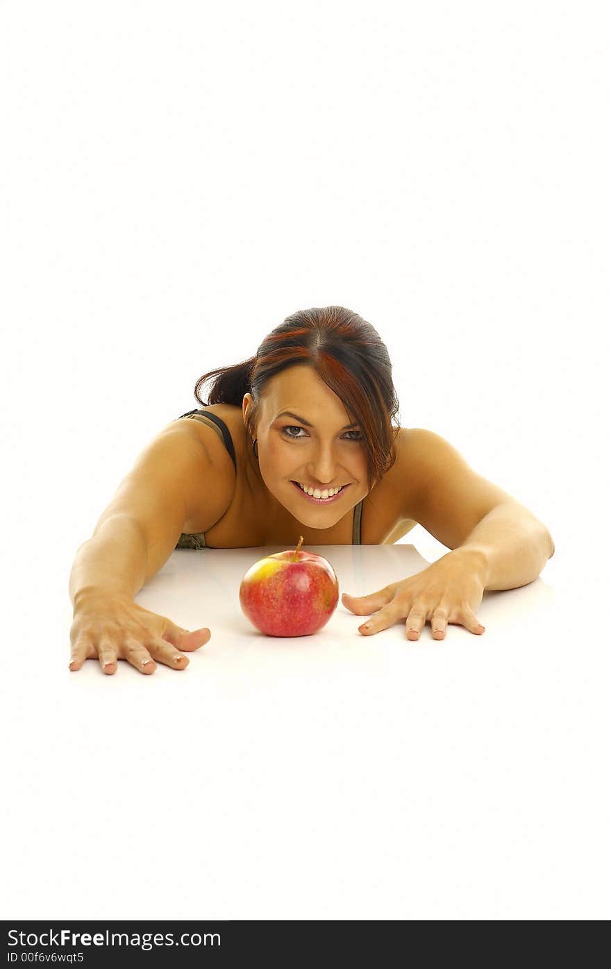 Woman exercising and red apple