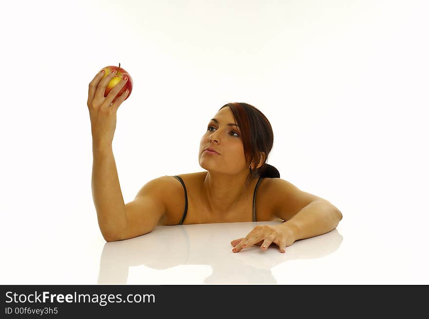 Woman exercising and red apple