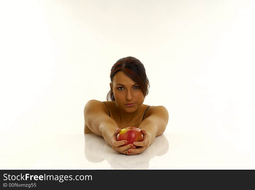 Woman exercising and red apple