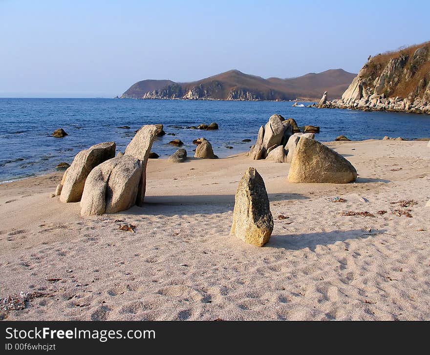 Coast of Sea of Japan, sand beach, stones, rocks, summer morning, landscape. Coast of Sea of Japan, sand beach, stones, rocks, summer morning, landscape