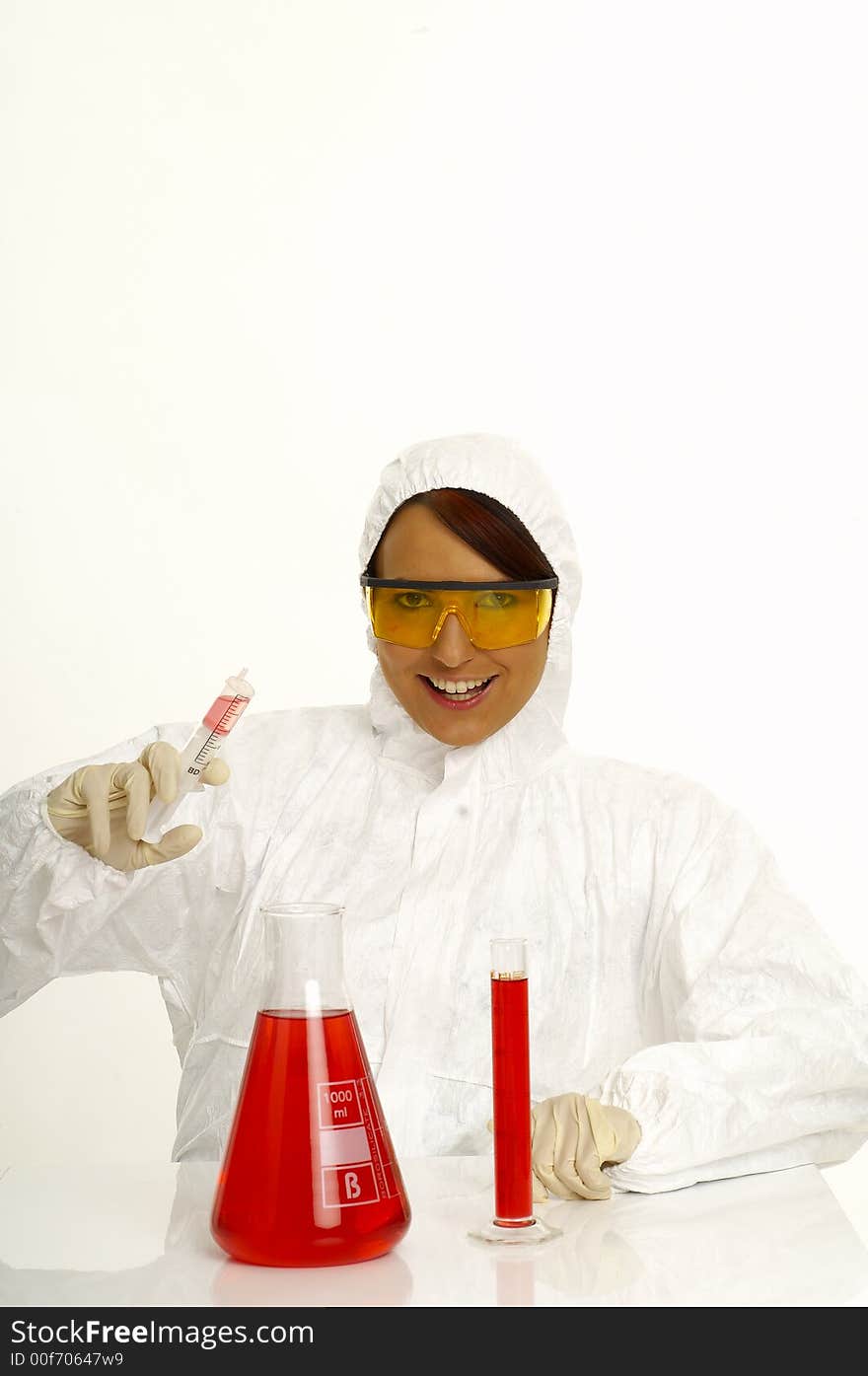 Beautiful female young scientist wearing glasses while doing a blood test. Beautiful female young scientist wearing glasses while doing a blood test