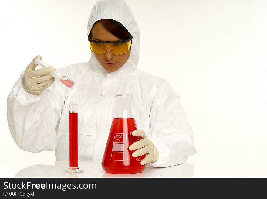 Beautiful female young scientist wearing glasses while doing a blood test. Beautiful female young scientist wearing glasses while doing a blood test