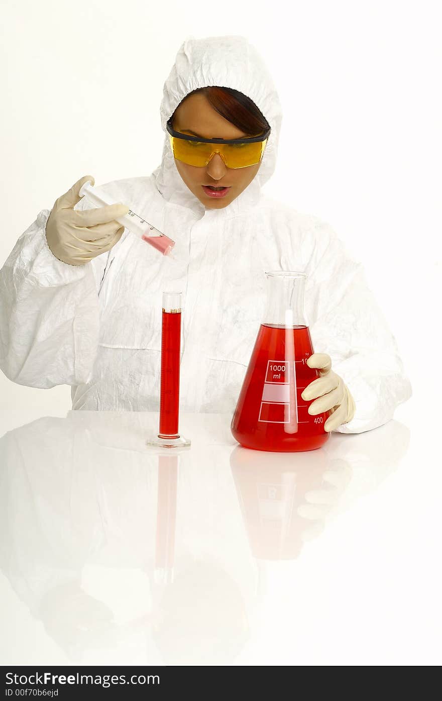 Beautiful female young scientist wearing glasses while doing a blood test. Beautiful female young scientist wearing glasses while doing a blood test