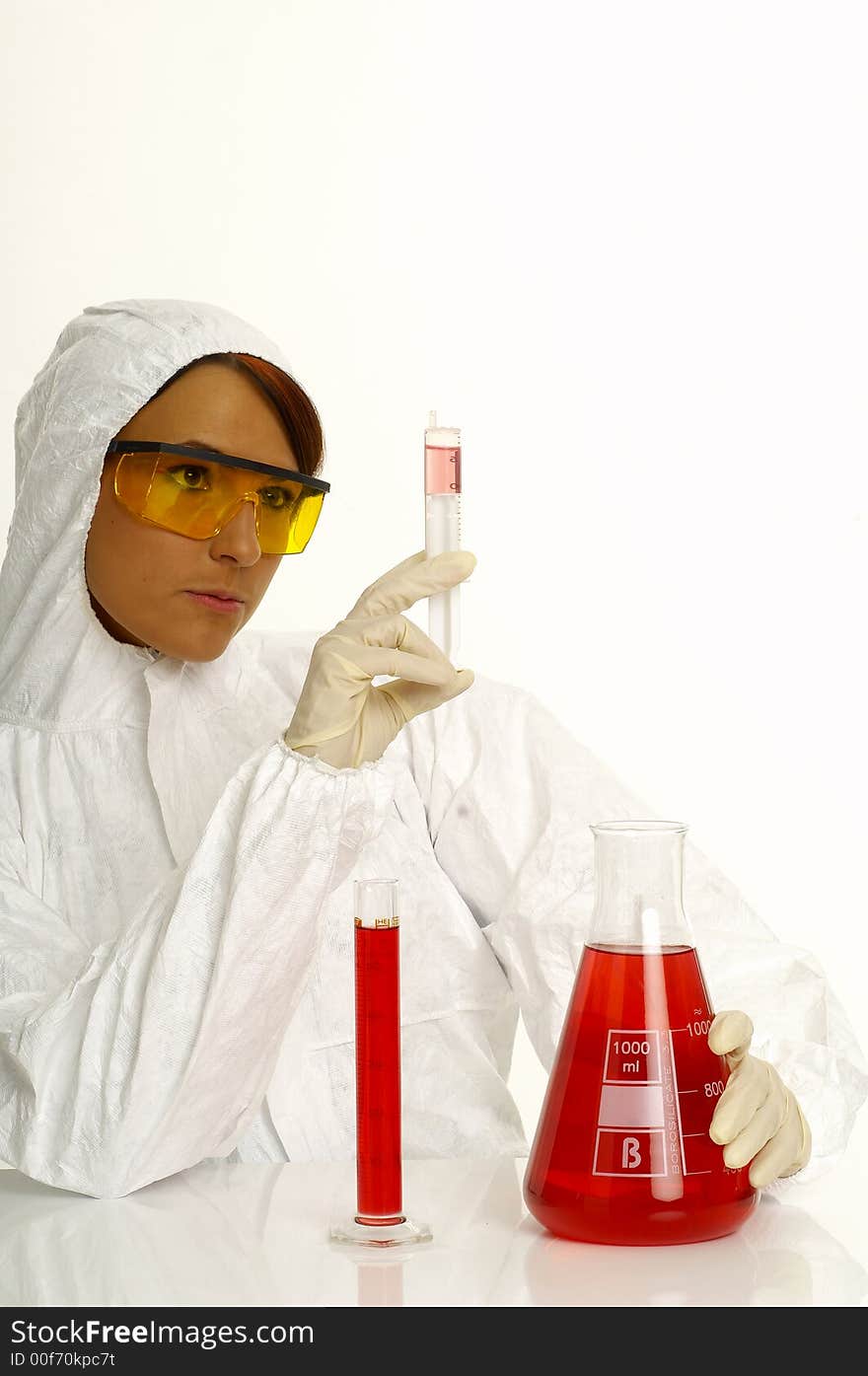 Beautiful female young scientist wearing glasses while doing a blood test. Beautiful female young scientist wearing glasses while doing a blood test