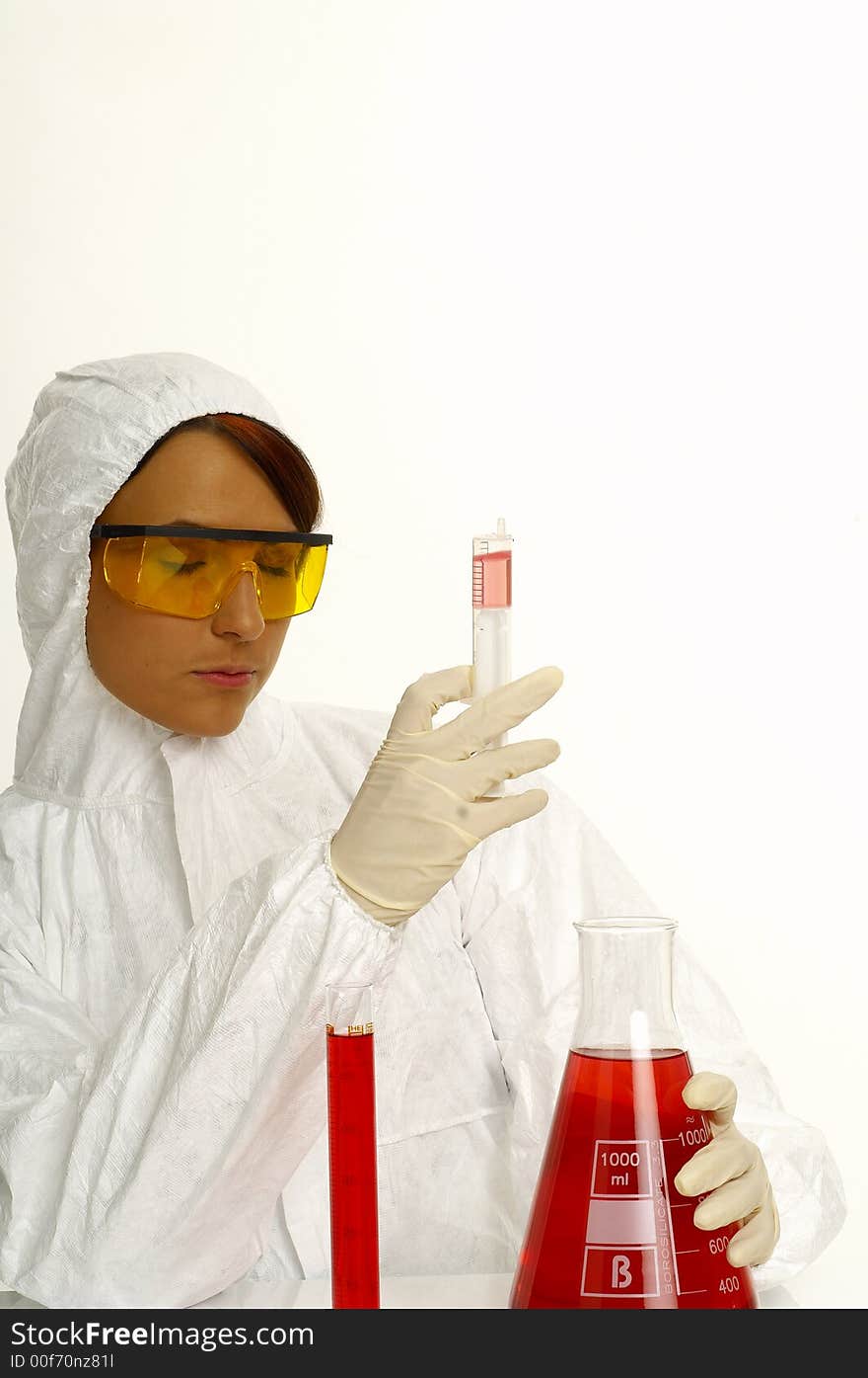 Beautiful female young scientist wearing glasses while doing a blood test. Beautiful female young scientist wearing glasses while doing a blood test