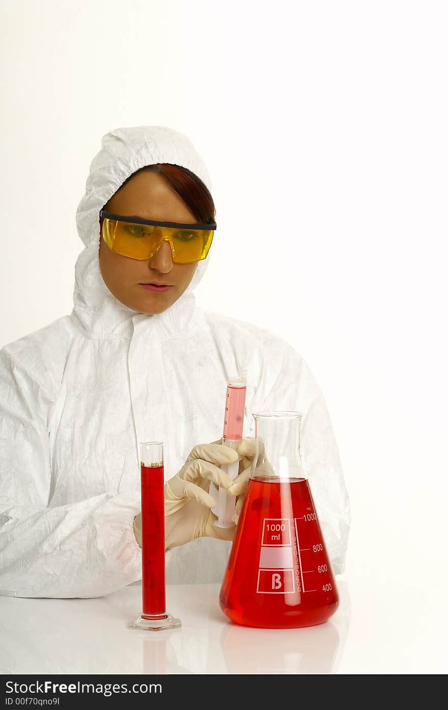 Beautiful female young scientist wearing glasses while doing a blood test. Beautiful female young scientist wearing glasses while doing a blood test