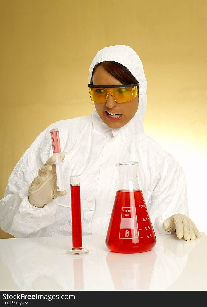 Beautiful female young scientist wearing glasses while doing a blood test. Beautiful female young scientist wearing glasses while doing a blood test