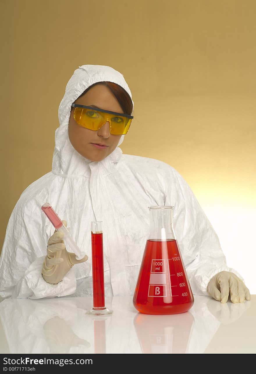 Beautiful female young scientist wearing glasses while doing a blood test. Beautiful female young scientist wearing glasses while doing a blood test