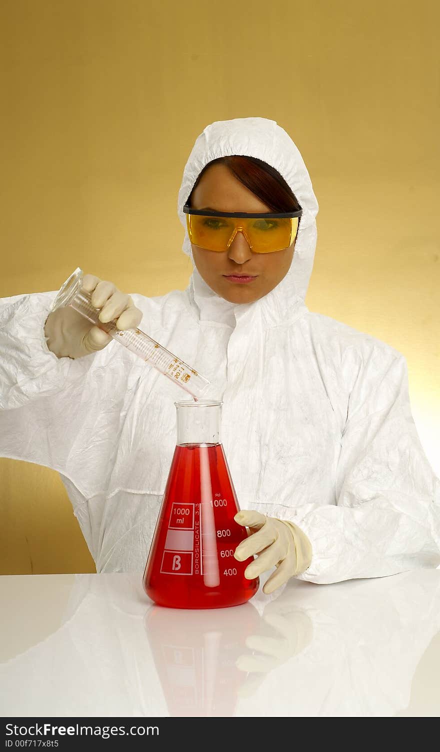 Beautiful female young scientist wearing glasses while doing a blood test. Beautiful female young scientist wearing glasses while doing a blood test