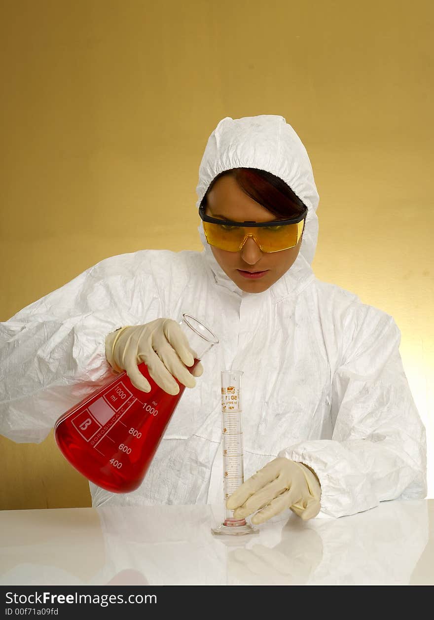 Beautiful female young scientist wearing glasses while doing a blood test. Beautiful female young scientist wearing glasses while doing a blood test