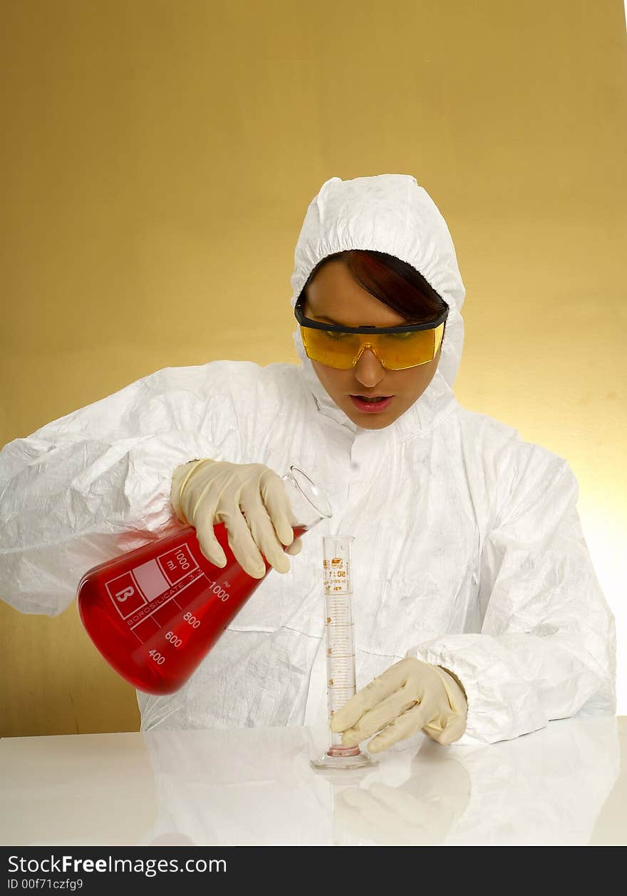 Beautiful female young scientist wearing glasses while doing a blood test. Beautiful female young scientist wearing glasses while doing a blood test