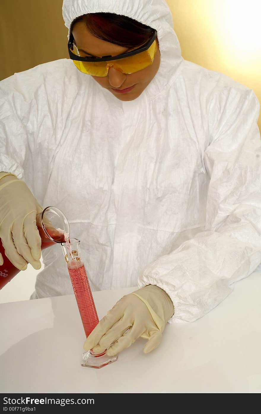 Beautiful female young scientist wearing glasses while doing a blood test. Beautiful female young scientist wearing glasses while doing a blood test