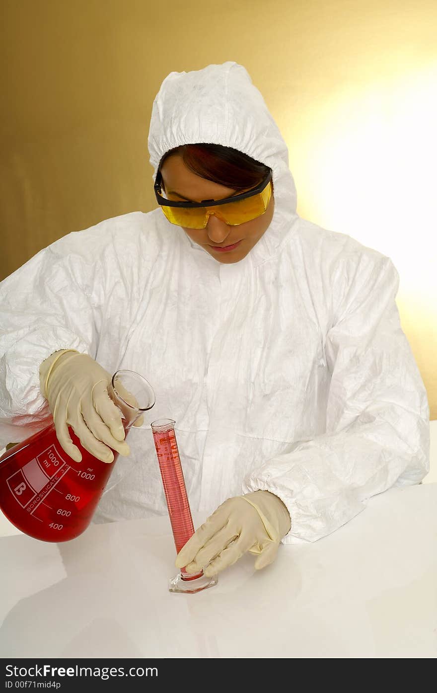 Beautiful female young scientist wearing glasses while doing a blood test. Beautiful female young scientist wearing glasses while doing a blood test