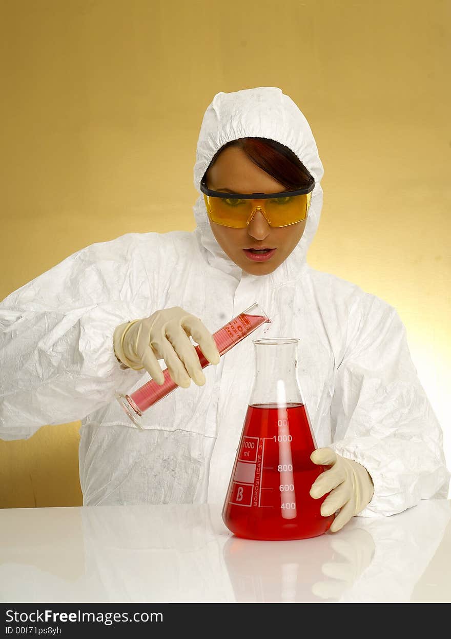 Beautiful female young scientist wearing glasses while doing a blood test. Beautiful female young scientist wearing glasses while doing a blood test