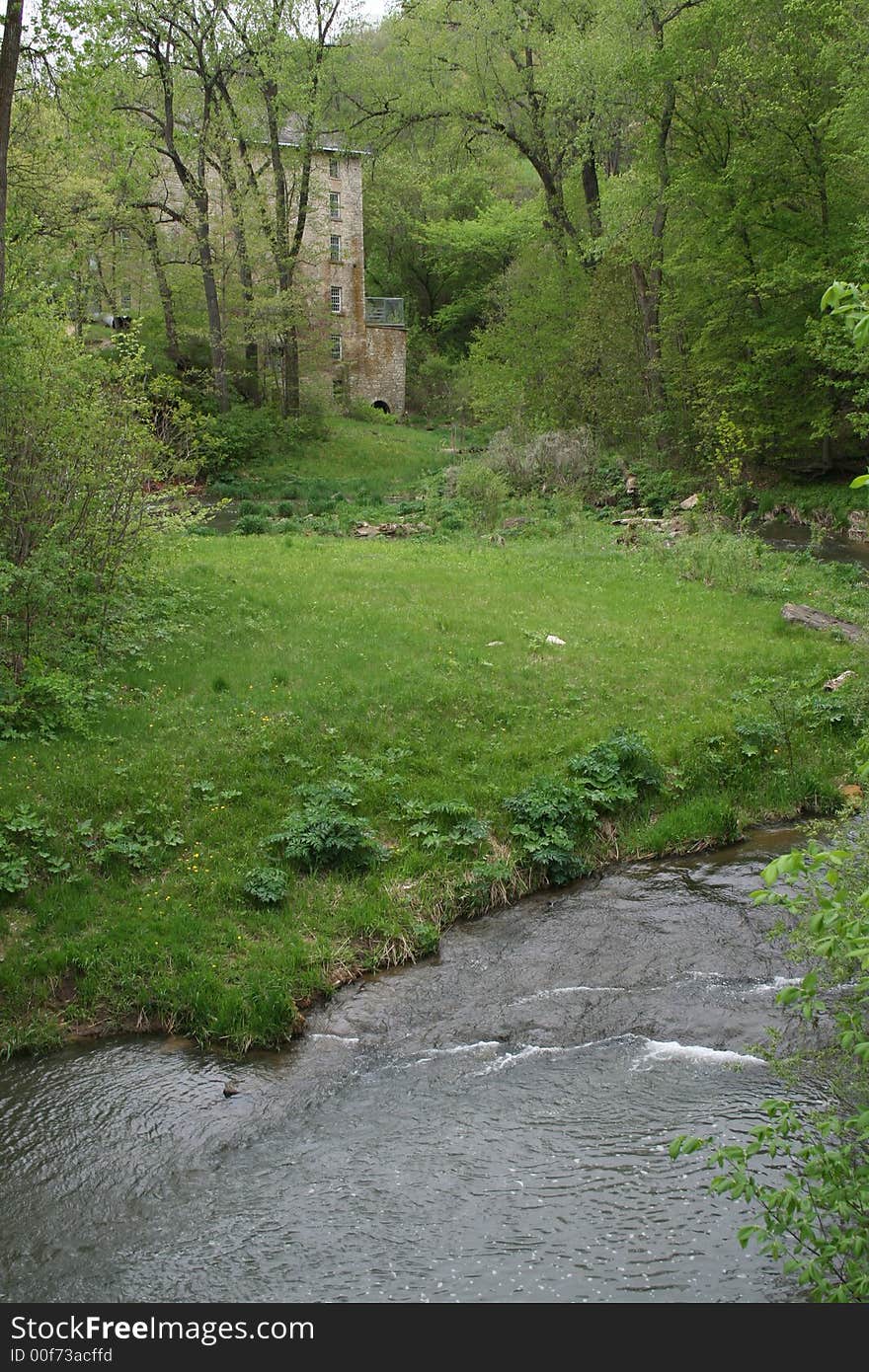 Old mill in woods along stream