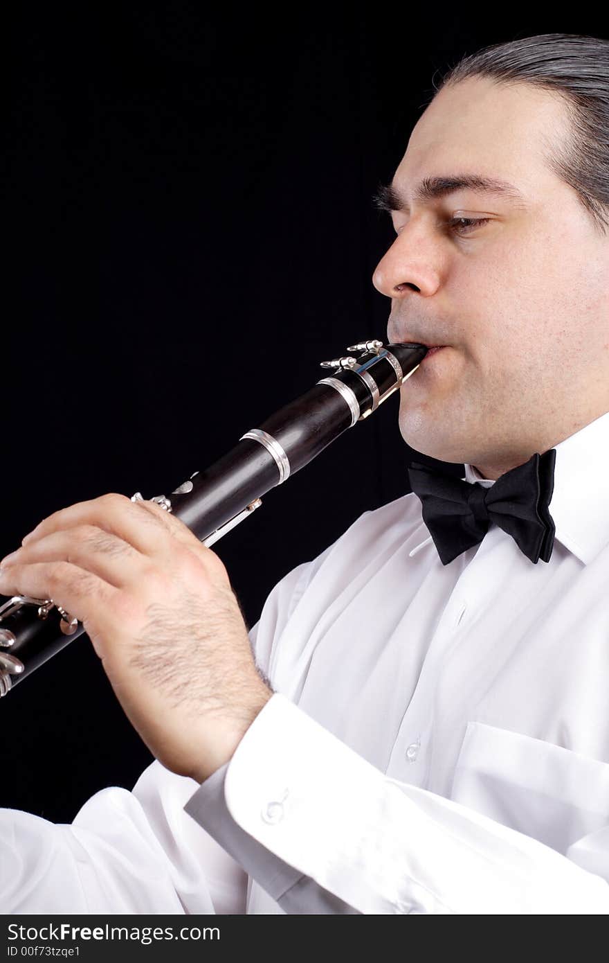 A man playing his wind instrument with expression. A man playing his wind instrument with expression.