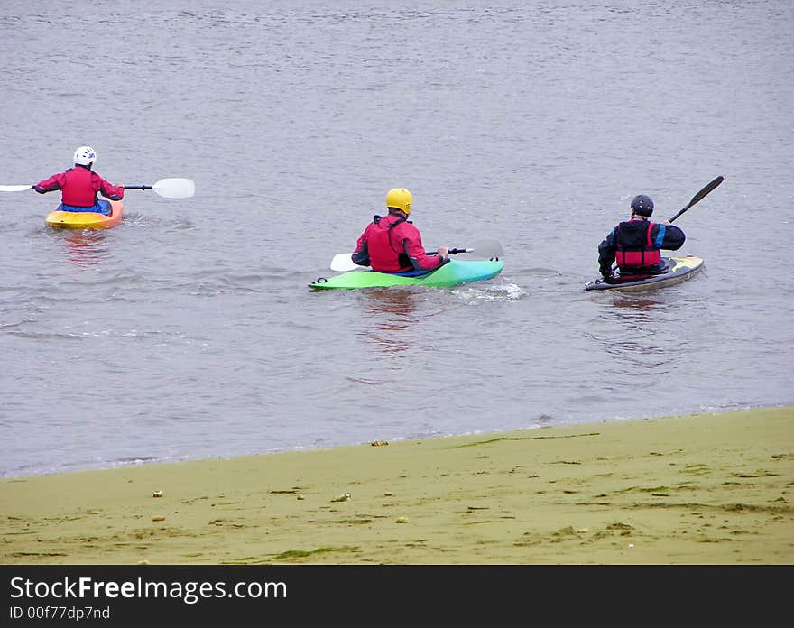 Three people having fun on the river