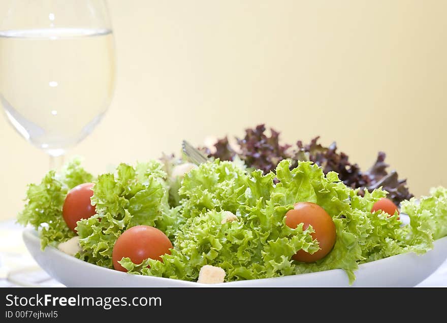 Mix of lettuces salad with tomato cherry on white bowl. Mix of lettuces salad with tomato cherry on white bowl