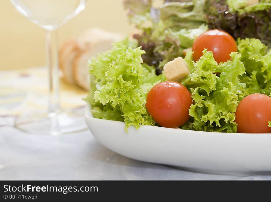 Mix of lettuces salad with tomato cherry on white bowl. Mix of lettuces salad with tomato cherry on white bowl